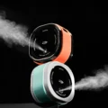 IKAPE elektrisches RDT Spray in Orange und Hellblau, beide geben einen feinen Nebel ab, auf schwarzem Hintergrund