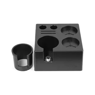 Schwarze Box von vorne, die runde Einlage steht daneben, die Schraube noch in der Aufnahme