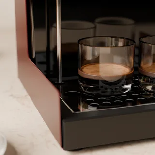 Das lange Entlüftungsrohr reicht neben einem Espressoglas in die flache Schale in der Küche
